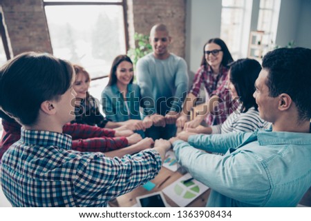 Blurred picture of cheerful college students guys race professional educational discussion coworking place hands fists shape circle present show power strength unity  casual shirts comfort office