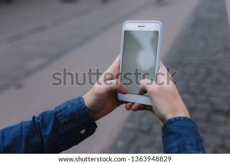Mock up of man holding device and touch screen