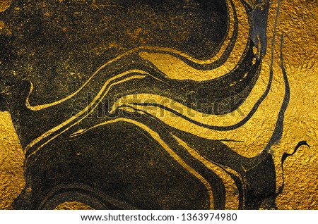Golden swirl, artistic design. Suminagashi – the ancient art of Japanese marbling. Paper marbling is a method of aqueous surface design. Black and gold paper texture.  Royalty-Free Stock Photo #1363974980