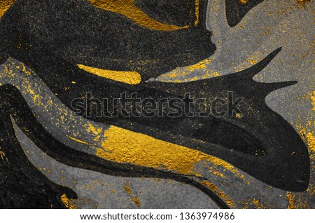 Golden swirl, artistic design. Suminagashi – the ancient art of Japanese marbling. Paper marbling is a method of aqueous surface design. Black and gold paper texture.  Royalty-Free Stock Photo #1363974986