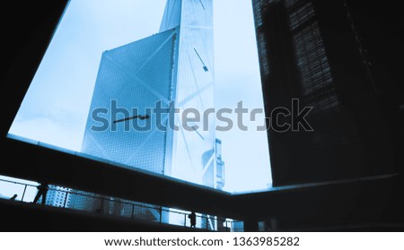 Blue glass windows of modern business office building, diagonal perspective, low angle view