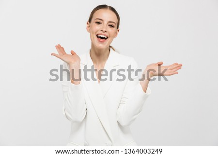 Image of a beautiful happy woman posing isolated over white wall background.