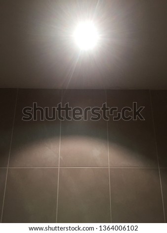 Tile wall with a spotlight reflection