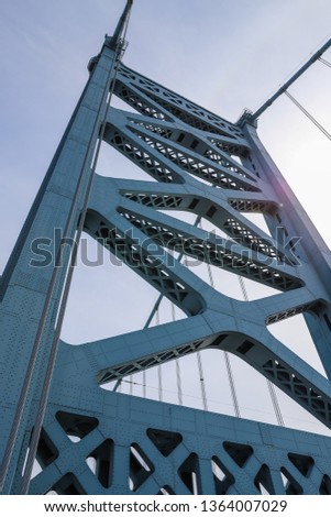 Close up view of metal tower construction of Ben Franklin  Bridge against blue sky. Suspension bridge across Delaware river, Pennsylvania, USA