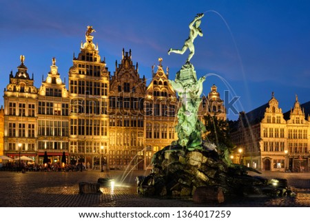 Antwerp famous Brabo statue and fountain on Grote Markt square illuminated at night and old houses. Antwerp, Belgium Royalty-Free Stock Photo #1364017259