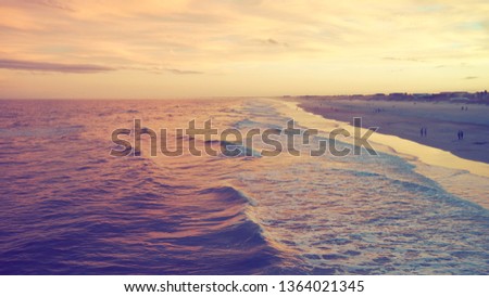 Ocean waves hitting the beach at sunset, vintage look