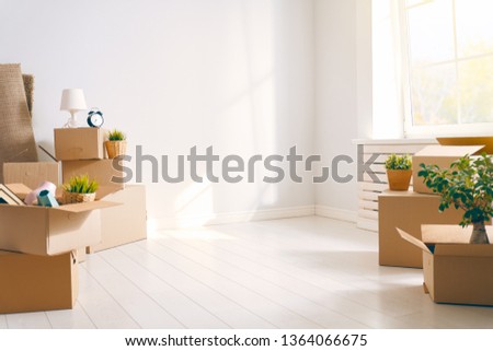 Cardboard boxes in empty new apartment. Royalty-Free Stock Photo #1364066675