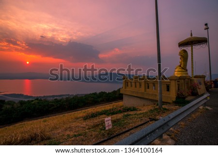 The background of the secret light in the evening, with the Buddha statue in the viewpoint Lam Takhong Korat Dam, able to take pictures without asking permission