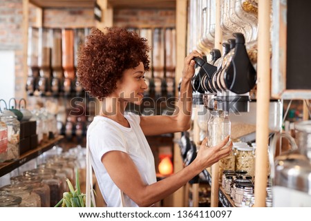 Woman Buying Cereals And Grains In Sustainable Plastic Free Grocery Store Royalty-Free Stock Photo #1364110097