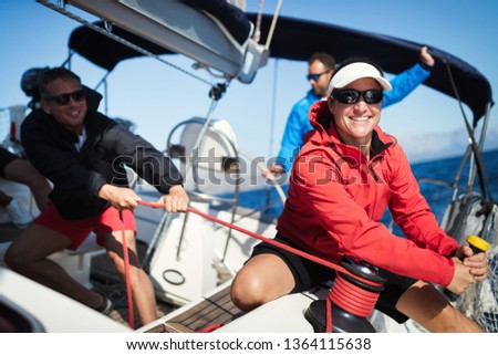 Attractive strong woman sailing with her boat Royalty-Free Stock Photo #1364115638