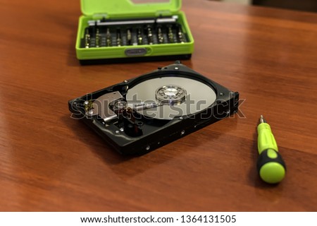 PC hard disk disassembled with screwdriver