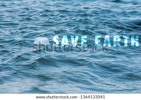 Save Earth awareness on Earth day and every day. A white trashed empty cup foam found left floating on the sea shore. A major problem of a Global issue. An awarenesses of Global environment concern.