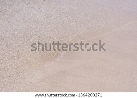 Wave of the sea on the sand beach.Nature summer background of sand beach.