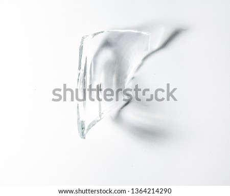 Parts of the broken cup jar glass isolated on white background with shadow lighting effect. Pieces of sharp broken glass. Concept of danger.