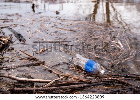 A plastic bottle in washed ashore next to the Mississippi River in La Crosse, Wisconsin after a flood