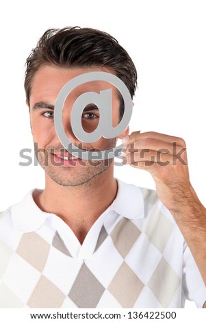 Man holding metallic at symbol over eye