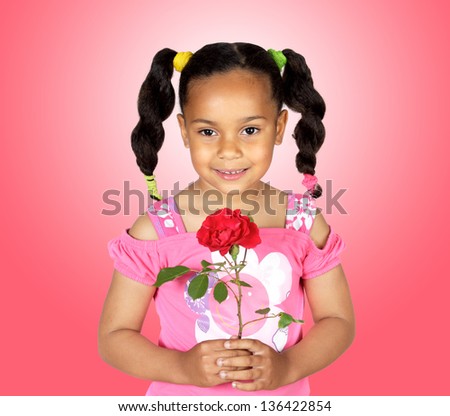 Smiling little girl with a red rose for gift on a over pink background