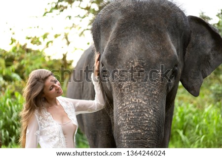 girl hugging an elephant in the jungle