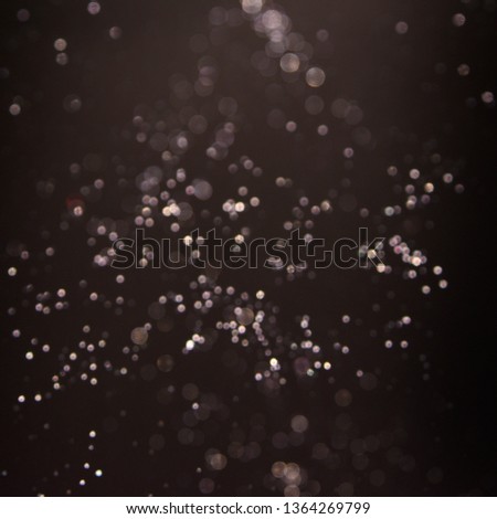 Texture background abstract black and white or silver Glitter and elegant for Christmas. Dust white. Sparkling magical dust particles. Magic concept. Abstract background with bokeh effect.