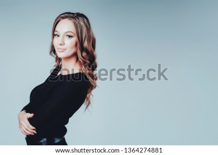 Woman young positive greeting service body care face pleasant procedure independence problem solving health black clothes gray studio model. Copy space right. Blue cyan toned photo.