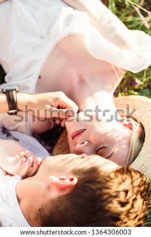 Beautiful portrait of bride and groom hug each other tender on sunset in lavander field
