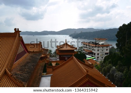 landscape of sun moon lake from tile roof of Xuanguang Temple in Taiwan