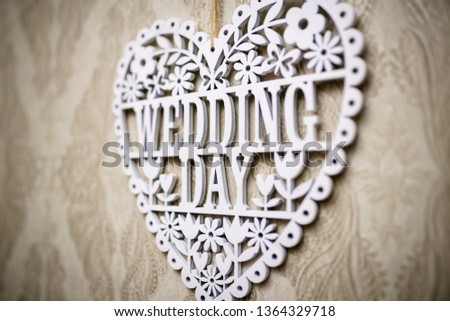Lettering the wedding day with white wooden letters. Background for the wedding day .