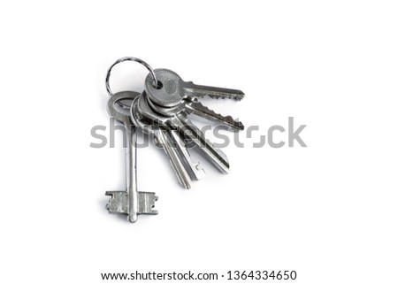 Several keys on a white isolated background. The keys to the apartment.