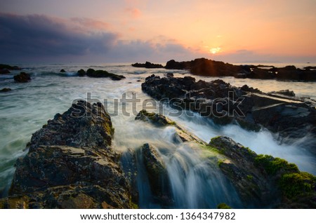 Amazing rock formations at Pandak beach, Terengganu, Malaysia.  Nature composition blur soft focus noise visible due to long exposure effect. 