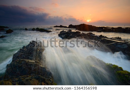 Amazing rock formations at Pandak beach, Terengganu, Malaysia.  Nature composition blur soft focus noise visible due to long exposure effect. 