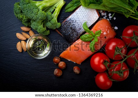 Fresh salmon with herbs, spices, vegetables, nuts. Healthy food, balanced diet concept. Top view