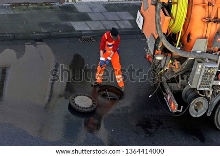 Sewer cleaning.
Sewage worker on cleans pipe
