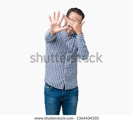 Handsome middle age elegant senior business man wearing glasses over isolated background covering eyes with hands and doing stop gesture with sad and fear expression. Embarrassed and negative concept.