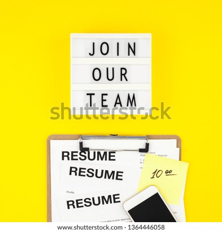 Creative top view flat lay of desk with join our team text on lightbox copy space on bold yellow background in minimal style. Concept of new job, hiring recruitment process, new team members screening