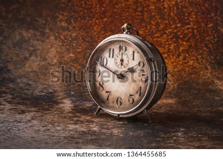 Old rustic clock front view arrangement on vibrant color background studio shot