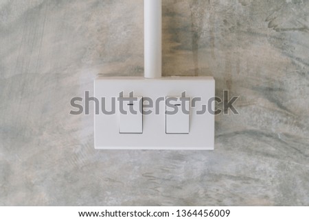 electrical light switch on cement wall background