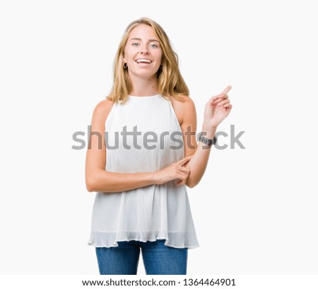 Beautiful young elegant woman over isolated background with a big smile on face, pointing with hand and finger to the side looking at the camera.