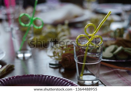Celebration on the way, a kids birthday party with straws already placed in glasses