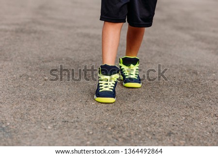 baby feet in sneakers close outdoors