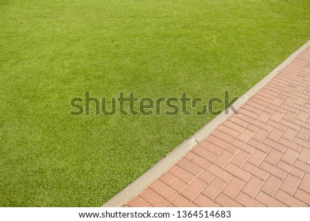 park outdoor aerial exterior wallpaper pattern with diagonal board between green grass and brown brick paved road background textured surfaces with empty copy space for your text