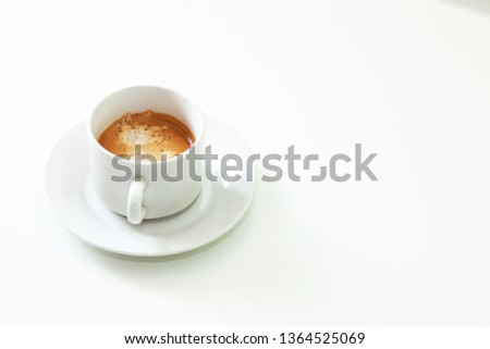Cup of coffe in white office desk. Selective focus. White work background with a natural light