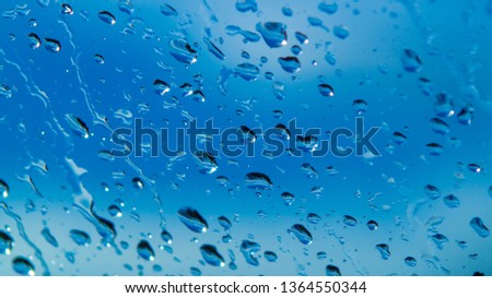 Rain Drops Relecting on Window Glass