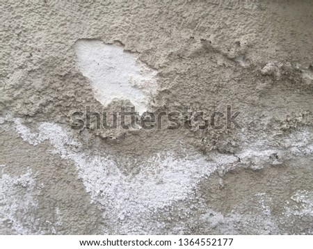 Rough dirty wall covered with cracked plaster surface