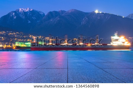 empty parkling lot with skyline of vancouver at night.