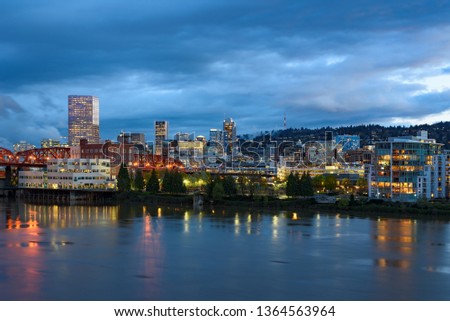Evening twilight view of Portland, Oregon downtown from Willamette river bank