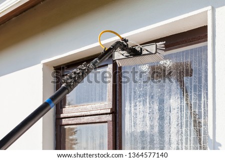 Equipment for washing and cleaning the window from the outside Royalty-Free Stock Photo #1364577140