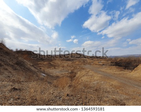 landscape , mountains and canyon , sand and beige, the sky with clouds, the picture is similar to the red planet Mars