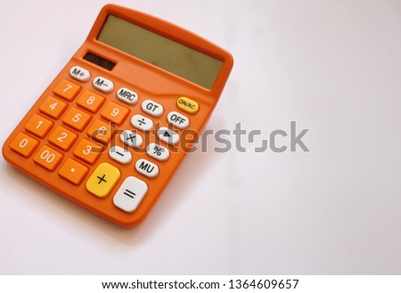 close up Orange calculator on a white background