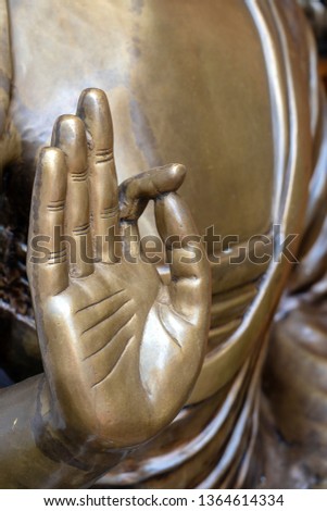 Beautiful bronze Buddha statue hand, close up . Mudras or Hand gestures