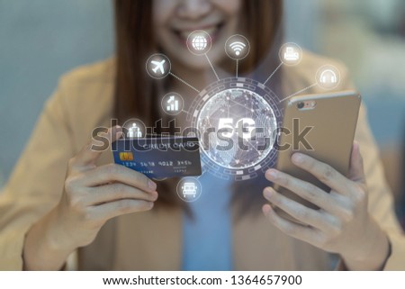 Closeup Asian woman using credit card by mobile for 5G technology with various icon internet of thing in department store, IOT and cashless concept, credit card mockup